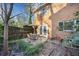 View of a backyard patio area with brick home and planting areas at 6520 Roswell Rd # 74, Atlanta, GA 30328