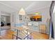 Open dining area with hardwood floors, seating, and kitchen view at 6520 Roswell Rd # 74, Atlanta, GA 30328