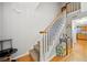 Inviting entryway with wood floors, staircase, and a glimpse of the kitchen at 6520 Roswell Rd # 74, Atlanta, GA 30328