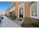 Charming brick townhouse featuring a black front door and manicured landscaping at 6520 Roswell Rd # 74, Atlanta, GA 30328