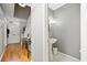 Entrance foyer with view of stairs, console table, and access to powder room at 6520 Roswell Rd # 74, Atlanta, GA 30328