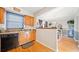 Kitchen with hardwood floors, wood cabinets, and an opening to the dining room at 6520 Roswell Rd # 74, Atlanta, GA 30328