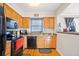 Kitchen with hardwood floors, wood cabinets, and black appliances at 6520 Roswell Rd # 74, Atlanta, GA 30328