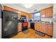 The kitchen offers wood cabinets, hardwood floors, and black appliances at 6520 Roswell Rd # 74, Atlanta, GA 30328