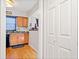 Partial kitchen view featuring wood cabinets, sink, and view into another room at 6520 Roswell Rd # 74, Atlanta, GA 30328