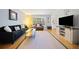 Comfortable living room with hardwood floors, a dark sofa, and a television on a stylish stand at 6520 Roswell Rd # 74, Atlanta, GA 30328