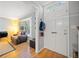 Cozy living room featuring hardwood floors, a white front door, and a comfortable recliner at 6520 Roswell Rd # 74, Atlanta, GA 30328