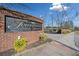 Townhomes at Sandy Springs community sign with brick facade and landscaping at 6520 Roswell Rd # 74, Atlanta, GA 30328