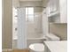 A bathroom with a shower/tub combination, and a white storage cabinet above the toilet at 10 Perimeter Summit Ne Blvd # 2405, Atlanta, GA 30319