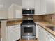 Well-lit kitchen boasts stainless steel oven and microwave, and granite countertops at 10 Perimeter Summit Ne Blvd # 2405, Atlanta, GA 30319