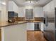 Bright kitchen with stainless steel appliances, granite countertops, and white cabinetry at 10 Perimeter Summit Ne Blvd # 2405, Atlanta, GA 30319