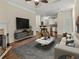 Spacious living room leading to kitchen featuring fireplace, gray sofa, and marble coffee table at 10 Perimeter Summit Ne Blvd # 2405, Atlanta, GA 30319