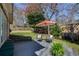 Backyard featuring a spacious deck with bench seating and an umbrella-covered table at 3261 Turtle Lake Se Ct, Marietta, GA 30067
