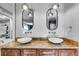 Elegant bathroom featuring double sinks with granite countertops, unique hanging light fixtures, and a herringbone backsplash at 3261 Turtle Lake Se Ct, Marietta, GA 30067