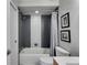 Stylish bathroom with gray and white tiled shower and tub, new toilet, and updated fixtures at 3261 Turtle Lake Se Ct, Marietta, GA 30067