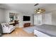 Spacious bedroom with hardwood floors, a large window, and a view into the ensuite bath with double sinks at 3261 Turtle Lake Se Ct, Marietta, GA 30067
