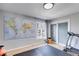 Bright bedroom featuring a large world map, hardwood floors, and a sliding door closet at 3261 Turtle Lake Se Ct, Marietta, GA 30067