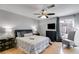 Cozy bedroom with a ceiling fan, dark furniture, hardwood floors, and natural light at 3261 Turtle Lake Se Ct, Marietta, GA 30067