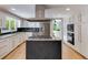 Open kitchen boasts white cabinets, granite counters, gas range and stainless steel appliances at 3261 Turtle Lake Se Ct, Marietta, GA 30067