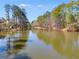 Picturesque lake view featuring serene water reflecting the surrounding trees, creating a peaceful atmosphere at 3261 Turtle Lake Se Ct, Marietta, GA 30067