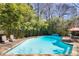 Beautiful swimming pool with a patio, outdoor seating and mature landscaping to add backyard privacy at 3261 Turtle Lake Se Ct, Marietta, GA 30067