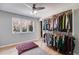 Bright walk-in closet featuring custom shelving, clothing racks, and a bench with a window at 3261 Turtle Lake Se Ct, Marietta, GA 30067
