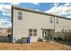 View of the backyard with a patio and a gray siding townhouse under a blue sky with light clouds at 7207 Brigidoon Rose, Douglasville, GA 30134