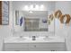 Bathroom featuring dual sinks, a large mirror, and decorative accents at 7207 Brigidoon Rose, Douglasville, GA 30134