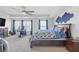 Comfortable bedroom featuring a bed and workspace with a large window at 7207 Brigidoon Rose, Douglasville, GA 30134