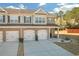 Charming townhome features a brick facade, attached garages, and a well-manicured lawn under blue skies at 7207 Brigidoon Rose, Douglasville, GA 30134