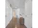 Hallway featuring hardwood floors, white doors, and a clean aesthetic at 7207 Brigidoon Rose, Douglasville, GA 30134