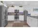 Well-equipped kitchen with stainless steel appliances and white cabinetry at 7207 Brigidoon Rose, Douglasville, GA 30134