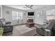 Cozy living room featuring a fireplace, comfortable seating, and hardwood floors at 7207 Brigidoon Rose, Douglasville, GA 30134