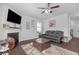 Cozy living room with fireplace, ceiling fan, and leather sofa at 7207 Brigidoon Rose, Douglasville, GA 30134