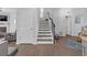 View of a staircase with wood treads, white risers, and iron railing in a bright home at 7207 Brigidoon Rose, Douglasville, GA 30134