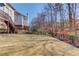 Large backyard featuring a trampoline and steps leading to the deck at 1175 Lamont Cir, Dacula, GA 30019