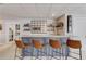 Basement wet bar with barstool seating, mirrored backsplash, and open shelving at 1175 Lamont Cir, Dacula, GA 30019