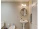 Charming powder room featuring pedestal sink and classic fixtures next to the door at 1175 Lamont Cir, Dacula, GA 30019