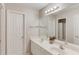 Bright bathroom with dual sinks, granite counters, and a large mirror at 1175 Lamont Cir, Dacula, GA 30019