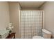Clean bathroom featuring a shower with a blue patterned shower curtain and tiled floor at 1175 Lamont Cir, Dacula, GA 30019