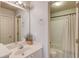 Well-lit bathroom featuring vanity with sink, and a shower with white tiled surround at 1175 Lamont Cir, Dacula, GA 30019