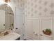 Charming bathroom with decorative wallpaper and marble countertop sink at 1175 Lamont Cir, Dacula, GA 30019
