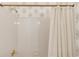 Bright bathroom featuring a white tile shower and modern shower curtain at 1175 Lamont Cir, Dacula, GA 30019