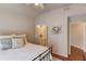 Comfortable bedroom with a full size bed, ceiling fan, and view to attached bathroom at 1175 Lamont Cir, Dacula, GA 30019