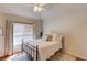 Comfortable bedroom with a ceiling fan, window with blinds, and decorative pillows at 1175 Lamont Cir, Dacula, GA 30019