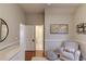 Comfortable chair with throw pillow in a bedroom with hardwood floors at 1175 Lamont Cir, Dacula, GA 30019