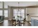 The dining area has hardwood floors, a decorative light fixture, an outside view, and is attached to the kitchen at 1175 Lamont Cir, Dacula, GA 30019