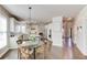 The dining area has hardwood floors, a decorative light fixture, an attached kitchen, and an outside view at 1175 Lamont Cir, Dacula, GA 30019