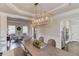 The dining room has a decorative light fixture, hardwood floors, a wooden table, and a living room attached at 1175 Lamont Cir, Dacula, GA 30019