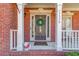 A welcoming front porch adorned with a decorative wreath, adding charm to the brick facade at 1175 Lamont Cir, Dacula, GA 30019